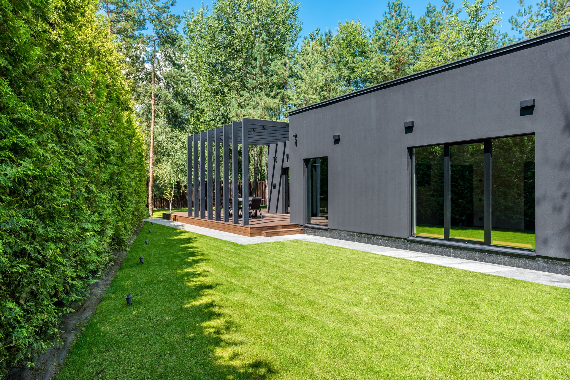 A neatly maintained green lawn beside a landscaped home